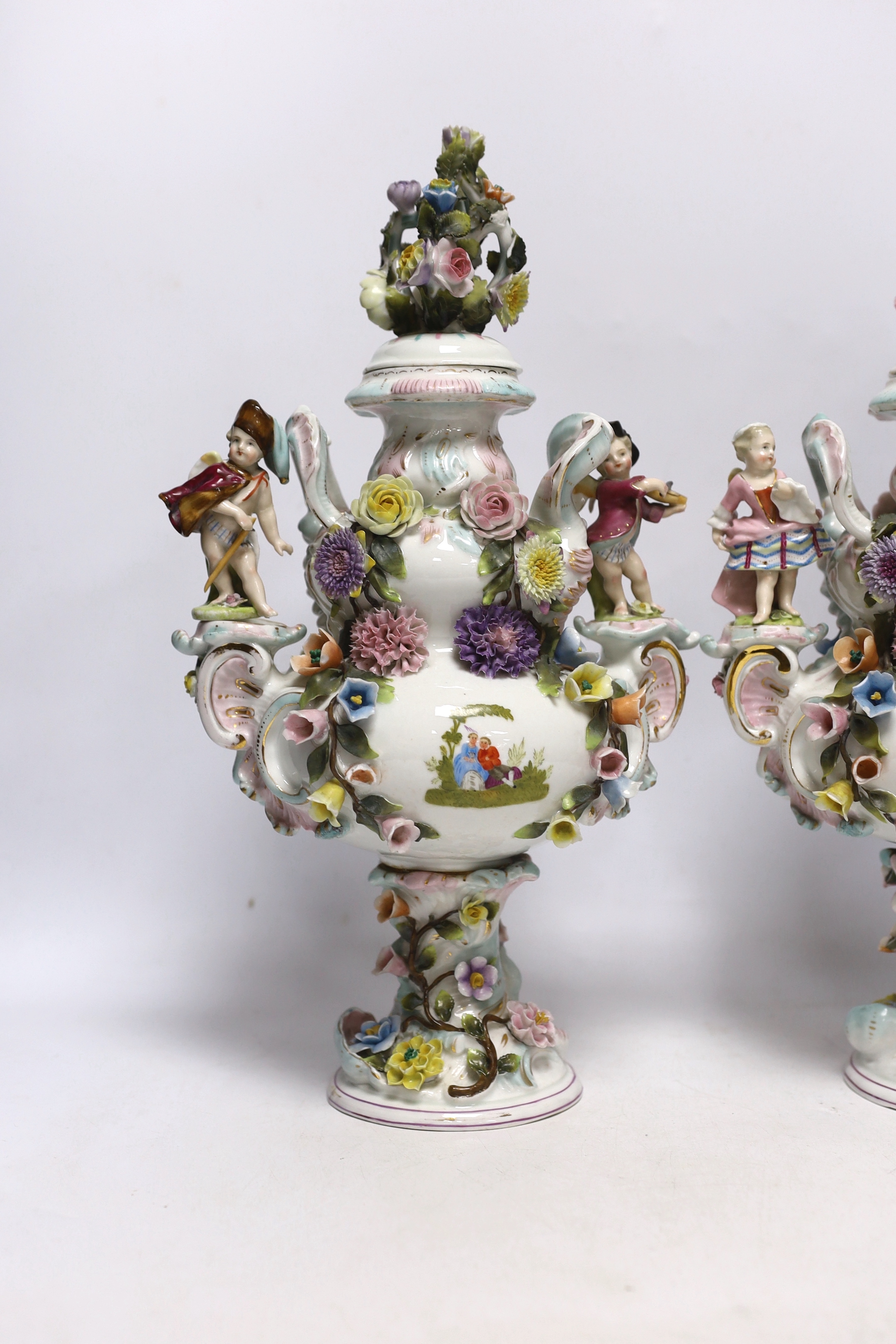 A pair of Sitzendorf floral encrusted and figural vases and covers, late 19th century, 36cm high